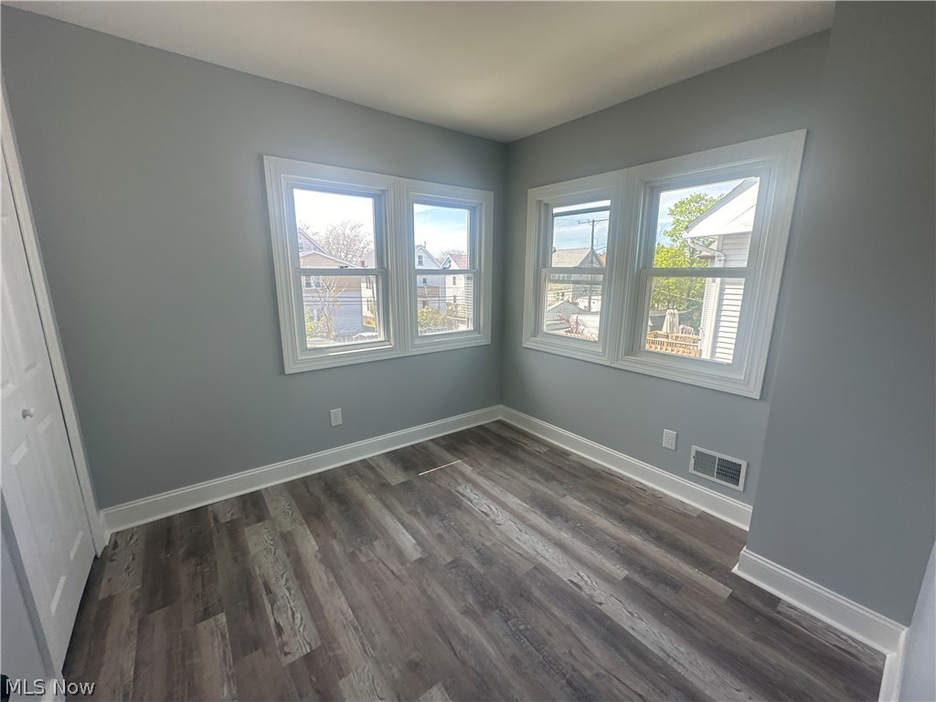 3550 Menlo Road Cleveland, OH 44120 - Photo 19 of 22 Spare room featuring a healthy amount of sunlight and dark wood-type flooring