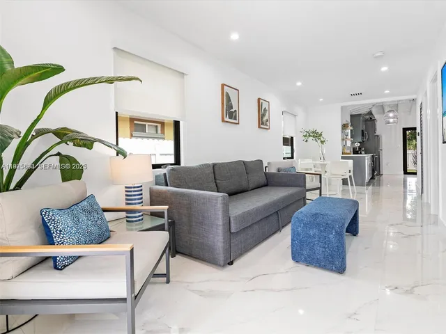 a living room with furniture rug and lamp