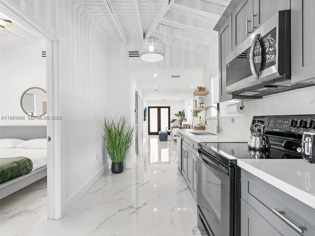 a kitchen with stainless steel appliances granite countertop a stove a sink and a refrigerator