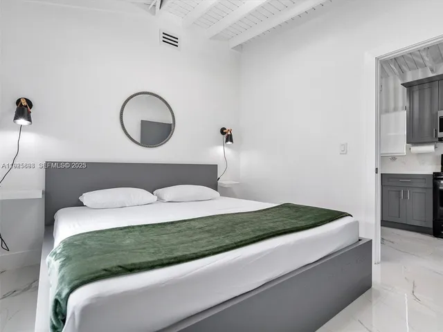 a bedroom with a bed and cabinets