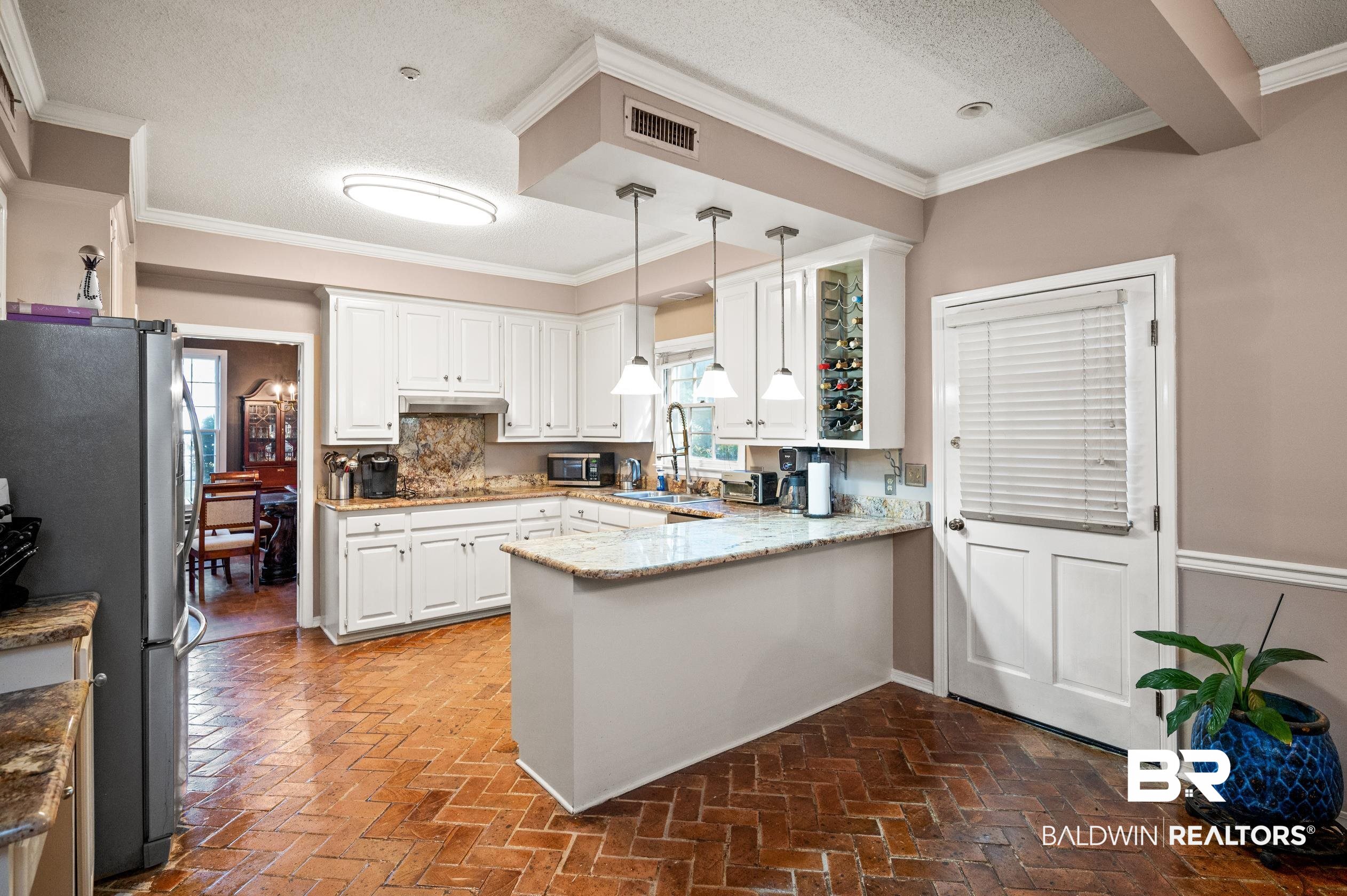6705 Ridgeland Road South Mobile, AL 36695 - Photo 11 of 44 Kitchen featuring pendant lighting, kitchen peninsula, stainless steel appliances, and a healthy amount of sunlight