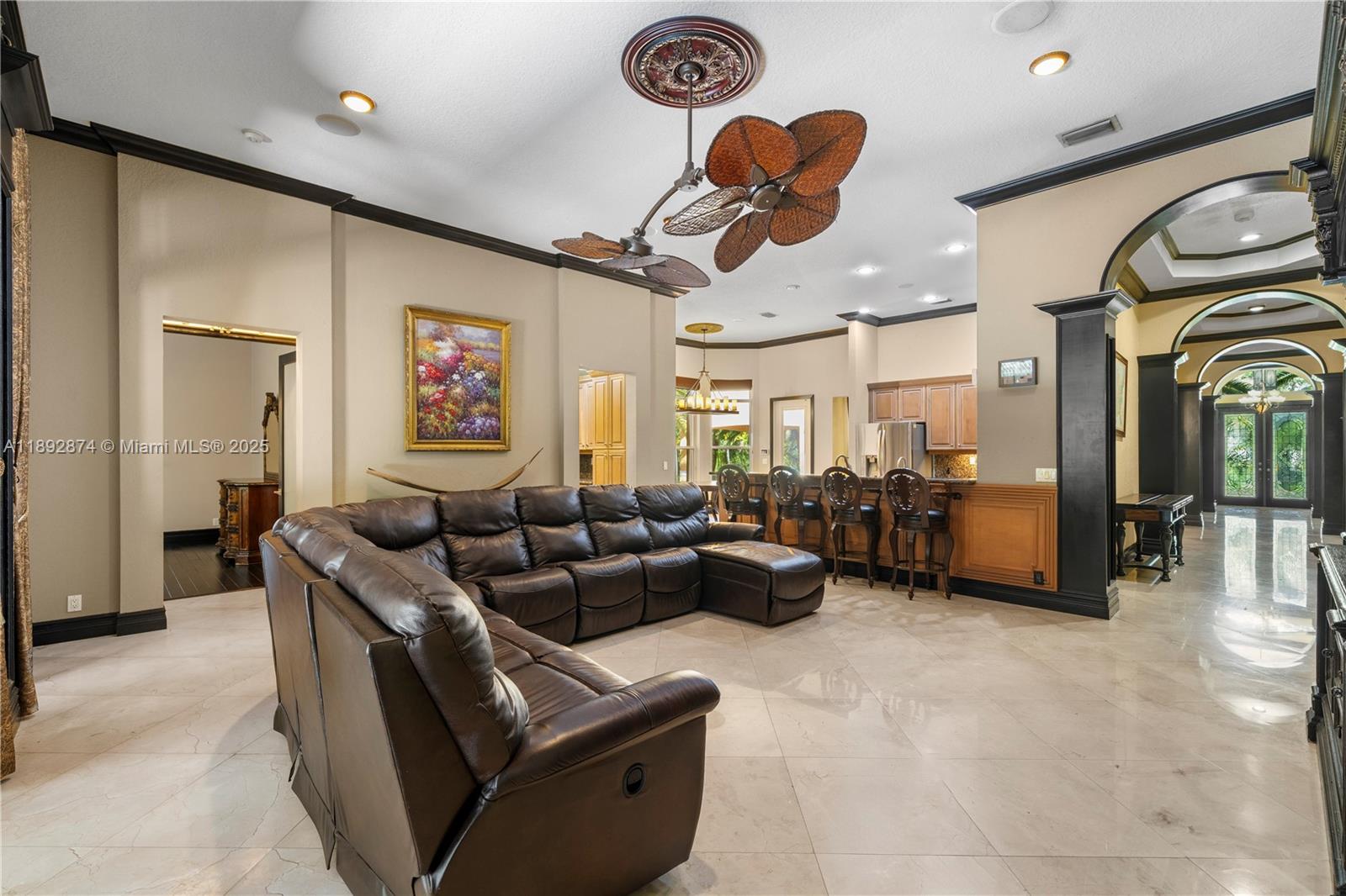 14130 Southwest 33rd Court Davie, FL 33330 - Photo 11 of 36 a living room with furniture gym equipment and a chandelier