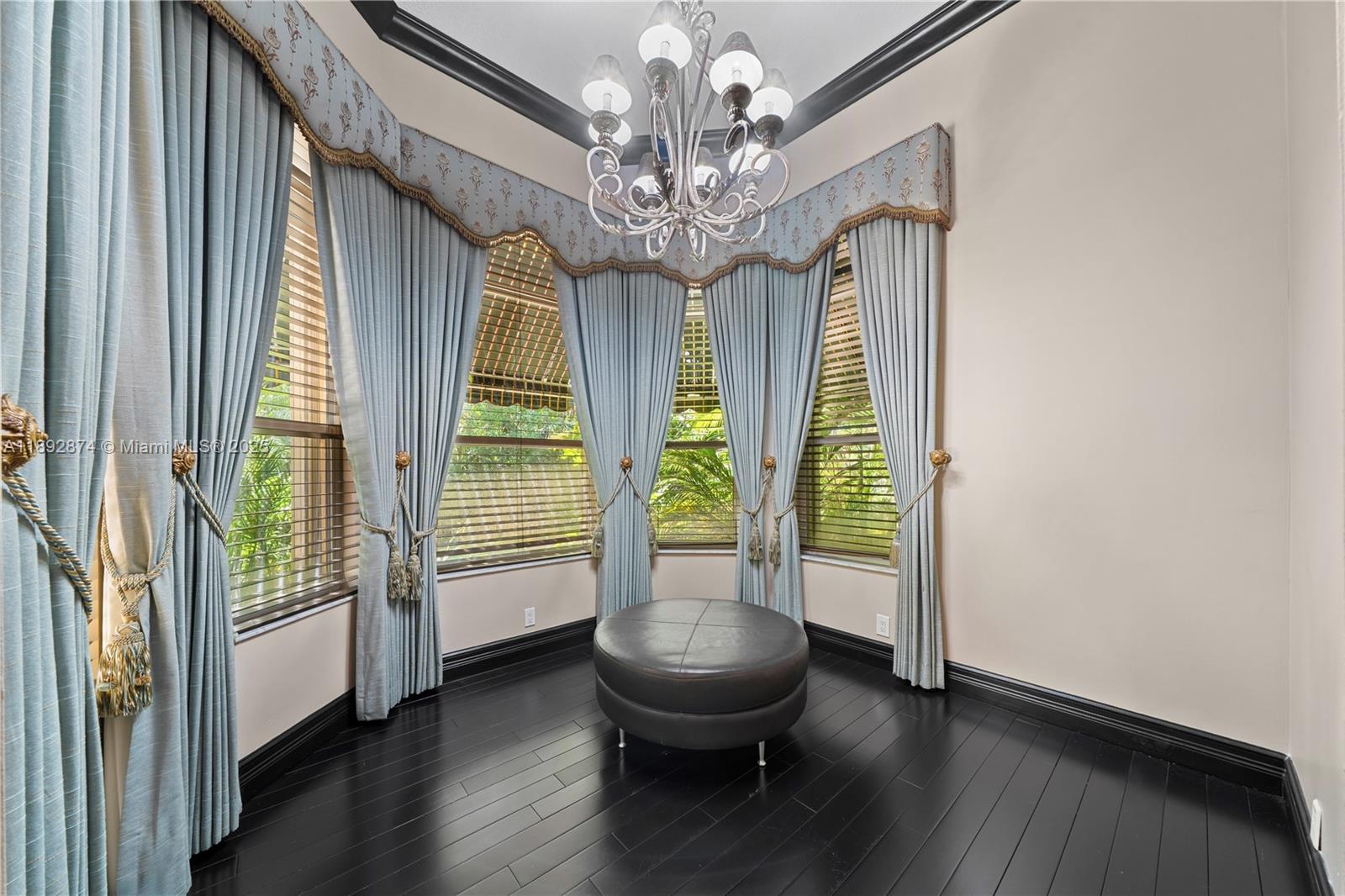 14130 Southwest 33rd Court Davie, FL 33330 - Photo 16 of 36 a living room with furniture and a chandelier