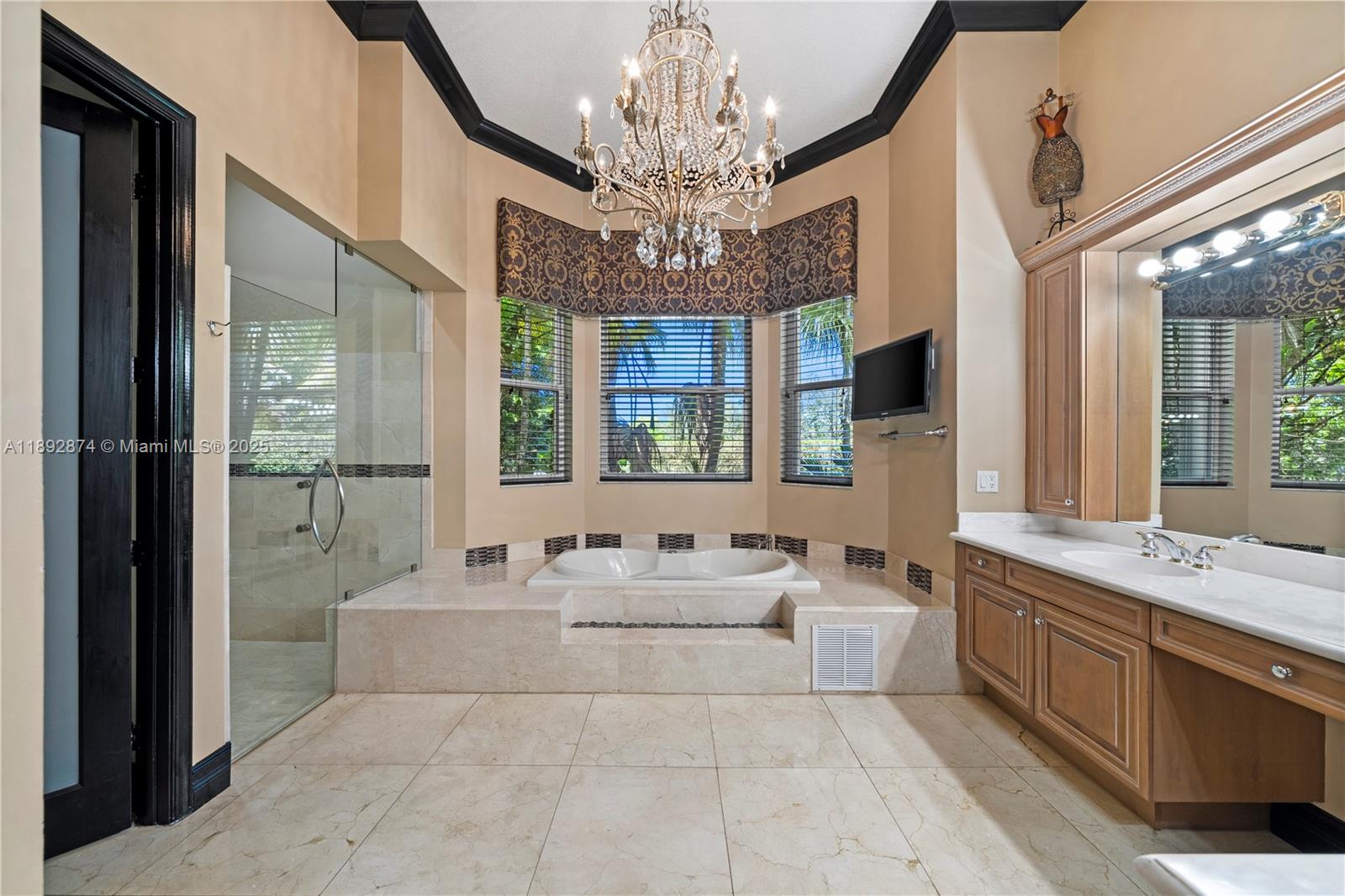 14130 Southwest 33rd Court Davie, FL 33330 - Photo 17 of 36 a spacious bathroom with a double vanity sink a large mirror and a shower