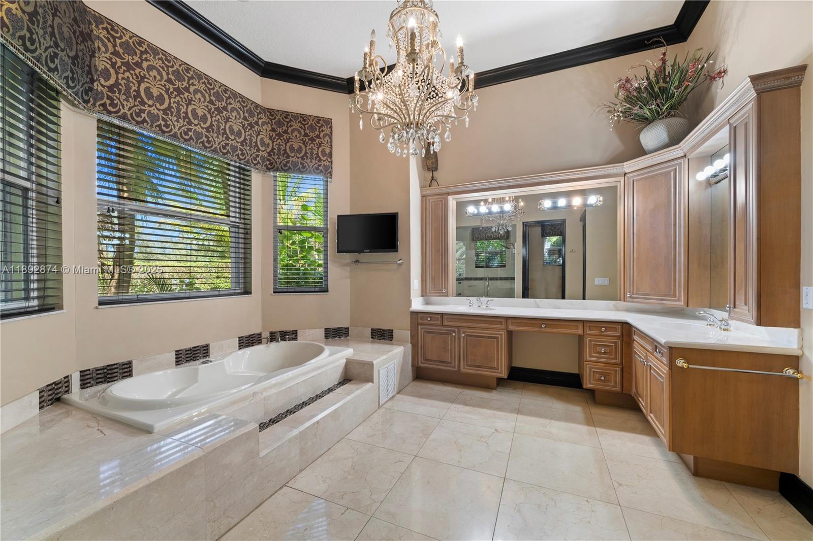 14130 Southwest 33rd Court Davie, FL 33330 - Photo 18 of 36 a bathroom with a tub sink and mirror