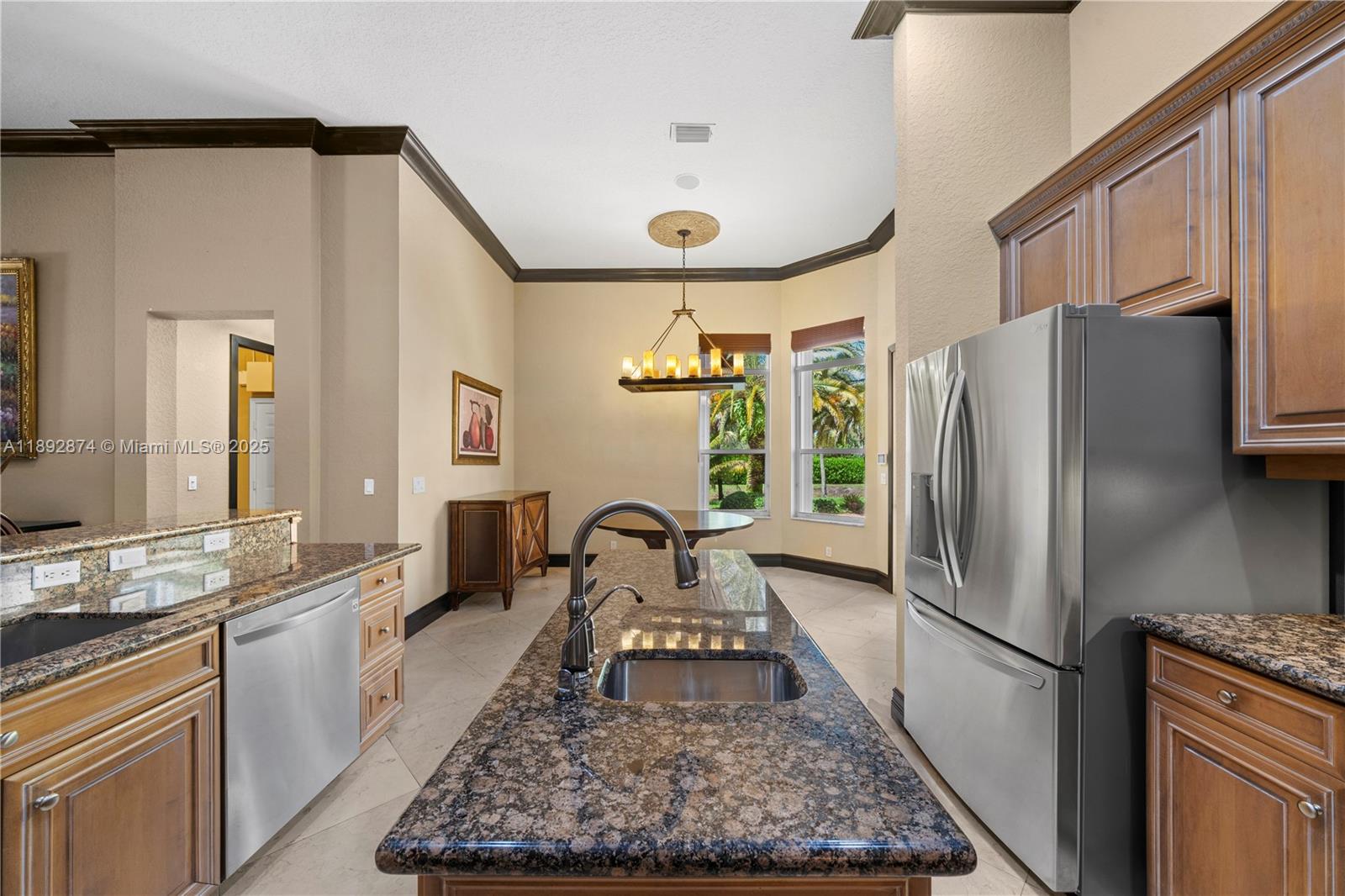 14130 Southwest 33rd Court Davie, FL 33330 - Photo 8 of 36 a kitchen with a refrigerator and a sink