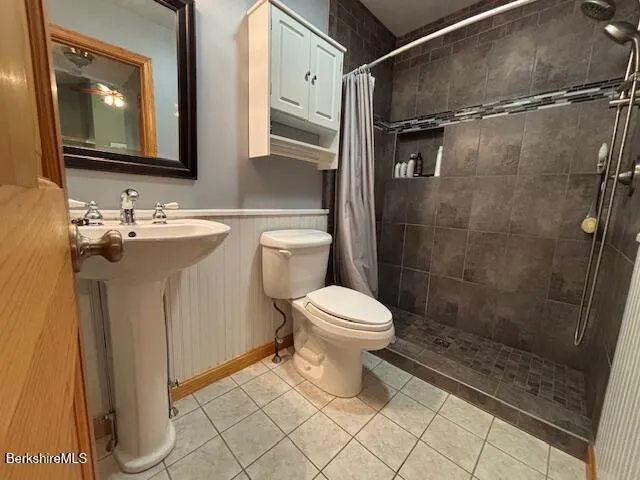 a bathroom with a toilet sink and shower