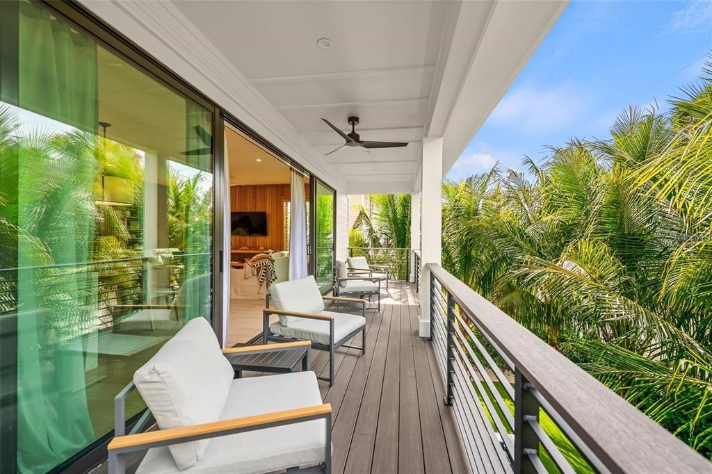 112 Maple Avenue Anna Maria, FL 34216 - Photo 20 of 91 a balcony with wooden floor and outdoor seating