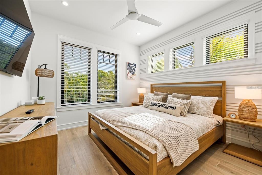 112 Maple Avenue Anna Maria, FL 34216 - Photo 24 of 91 a bedroom with a bed and a large window