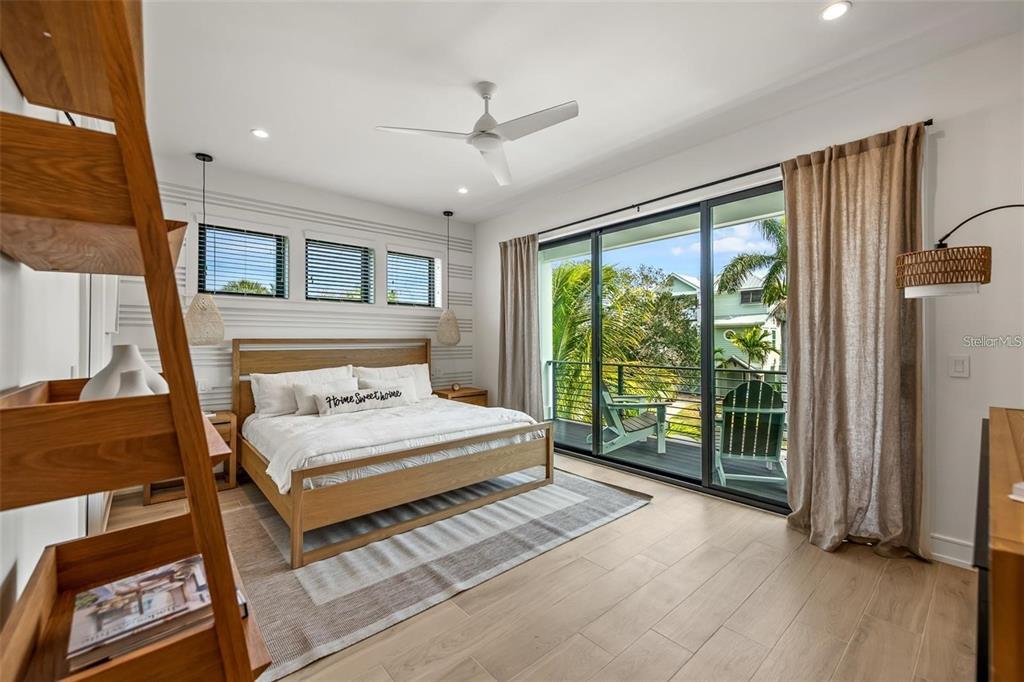 112 Maple Avenue Anna Maria, FL 34216 - Photo 34 of 91 a bedroom with a large bed and a large window
