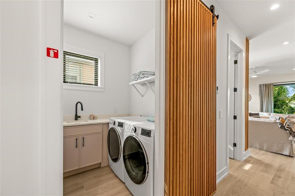 112 Maple Avenue Anna Maria, FL 34216 - Photo 38 of 91 a view of a hallway with washer and dryer