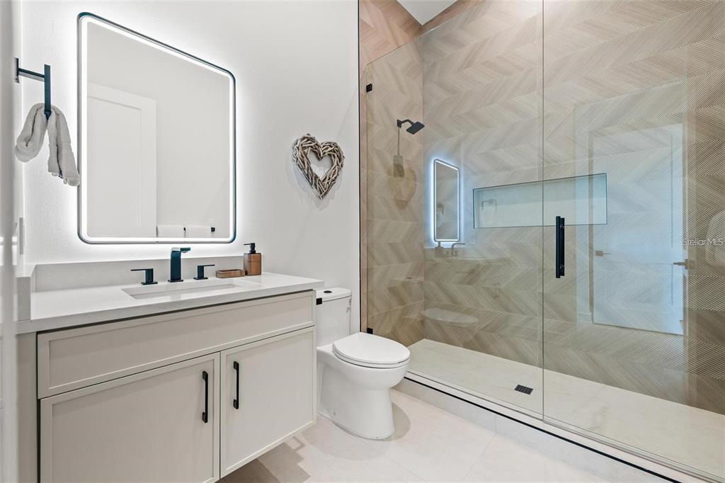 112 Maple Avenue Anna Maria, FL 34216 - Photo 57 of 91 a bathroom with a sink a toilet and shower