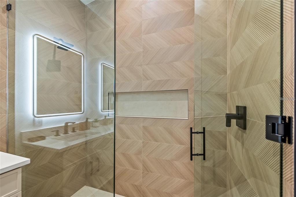 112 Maple Avenue Anna Maria, FL 34216 - Photo 58 of 91 a bathroom with a granite countertop sink a mirror and shower