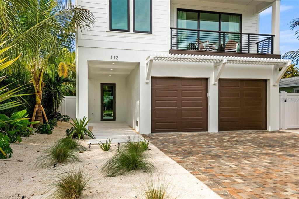 112 Maple Avenue Anna Maria, FL 34216 - Photo 6 of 91 a front view of a house with a yard and garage