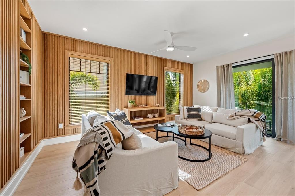112 Maple Avenue Anna Maria, FL 34216 - Photo 8 of 91 a living room with furniture a flat screen tv and a large window