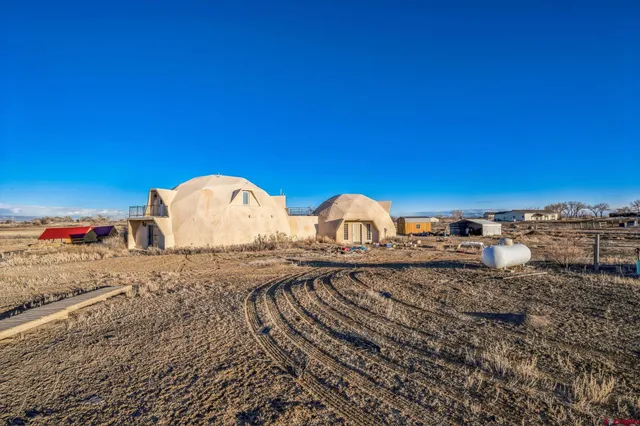 a view of a wooden house with a yard