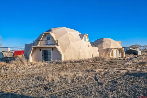 a view of a wooden house with a yard