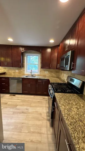 a bathroom with a sink a toilet and bathtub
