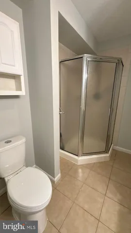 a bathroom with a shower and a mirror