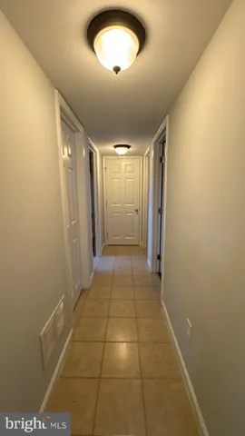 an empty room with wooden floor and closet area