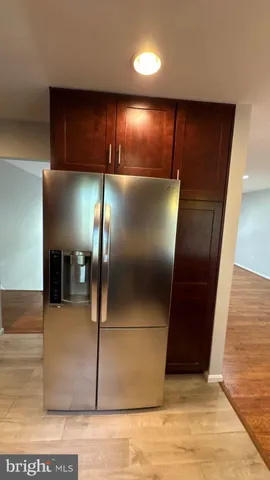 a large kitchen with a stove a sink and a microwave