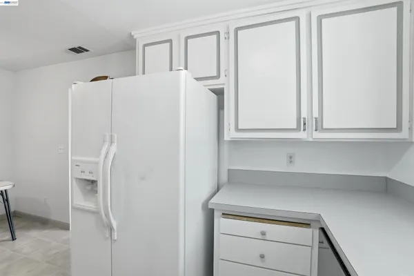 a white refrigerator freezer sitting inside of a kitchen