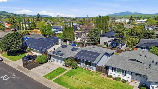 an aerial view of a house with a garden and lake view