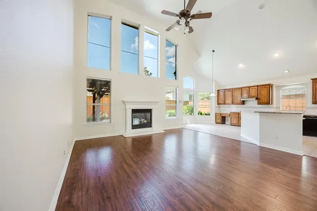 a view of a kitchen with wooden floor and a kitchen