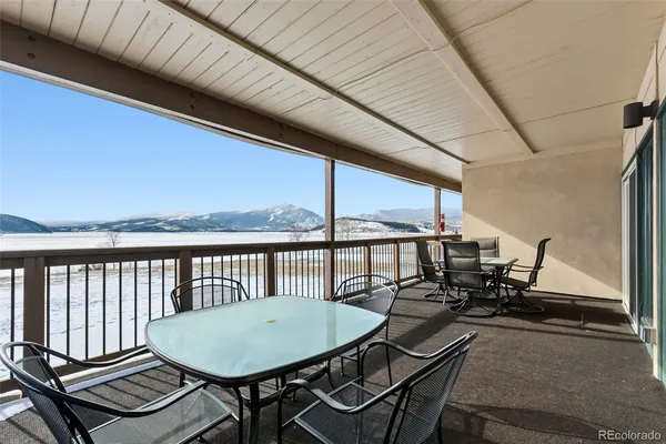 a view of a balcony dining area with furniture