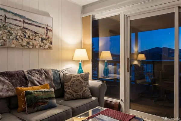 a living room with furniture and a glass door