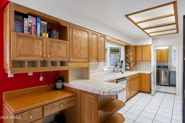 a large kitchen with stainless steel appliances granite countertop a stove a sink dishwasher and refrigerator