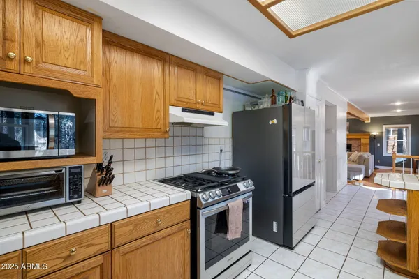 a view of a living room with furniture and wooden floor
