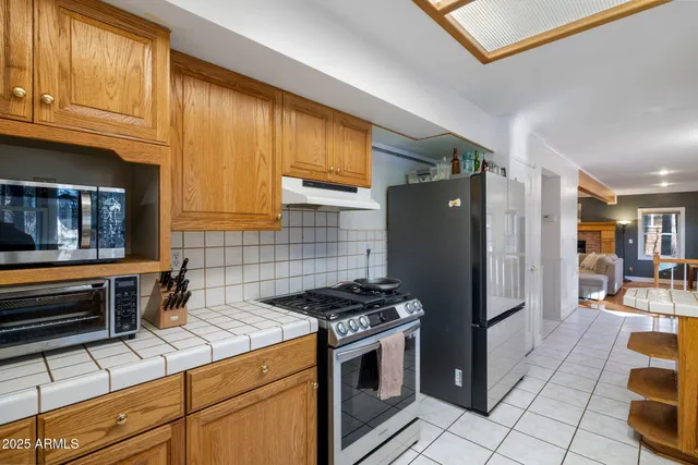 a view of a living room with furniture and wooden floor
