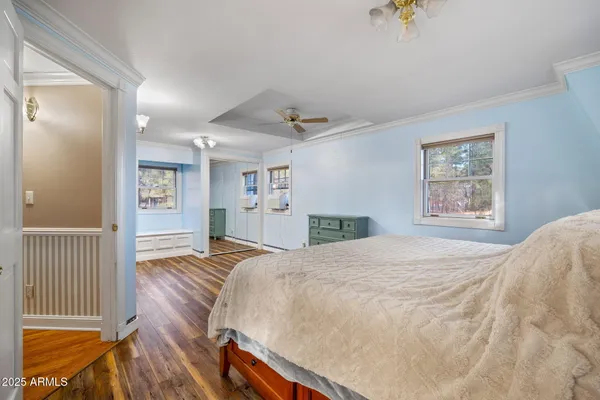 a bedroom with a bed and a chandelier