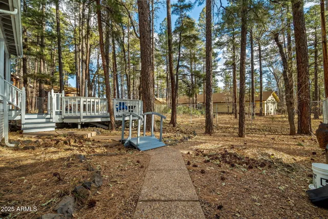 a view of a chair and table on the wooden deck