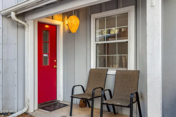 a view of empty room with window and ceiling fan