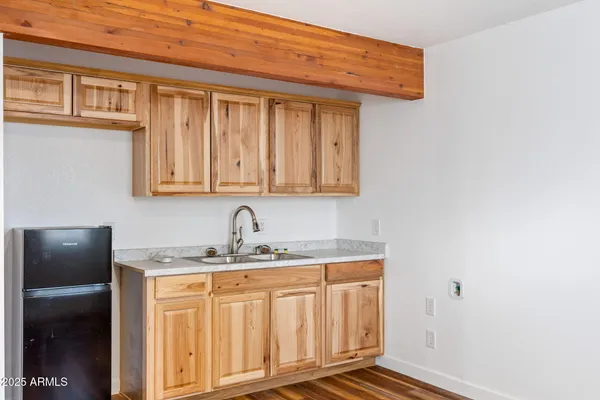 a bathroom with a granite countertop sink toilet and mirror