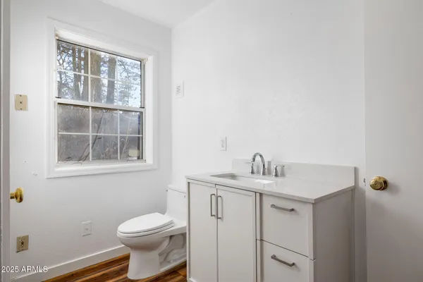 a living room with furniture fireplace and a window
