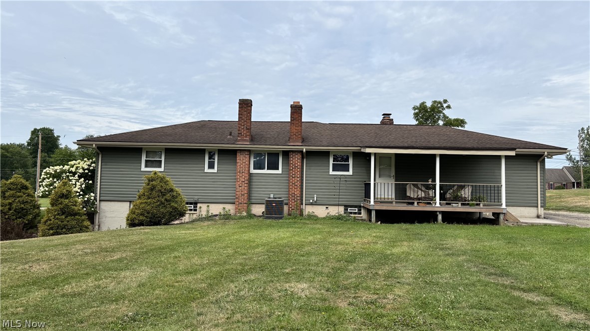 11784 Chamberlain Road Mantua, OH 44255 - Photo 43 of 50 Charming ranch-style home featuring a brick chimney, covered front porch, and horizontal siding exterior