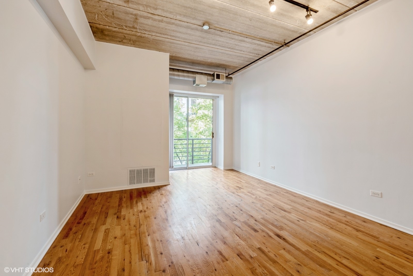 1440 South Michigan Avenue, Unit 322 Chicago, IL 60605 - Photo 2 of 11 a view of empty room with wooden floor and fan