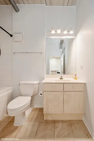 a bathroom with a sink a toilet and mirror