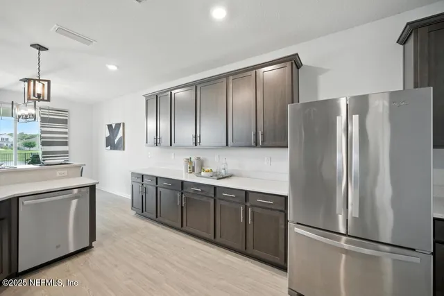 a kitchen with stainless steel appliances a refrigerator and a stove