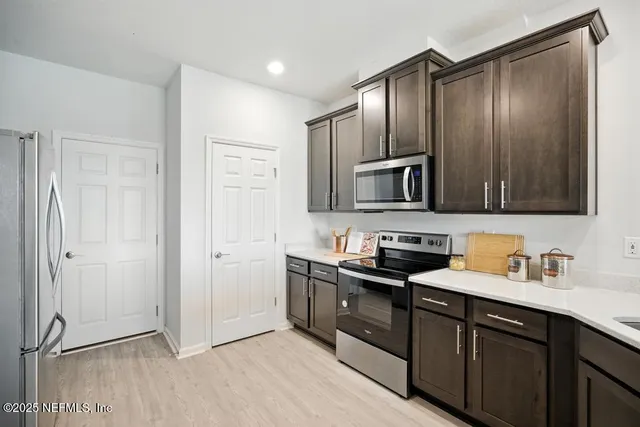 a kitchen with a sink stove and refrigerator