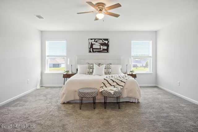 a bed room with a bed and a chair