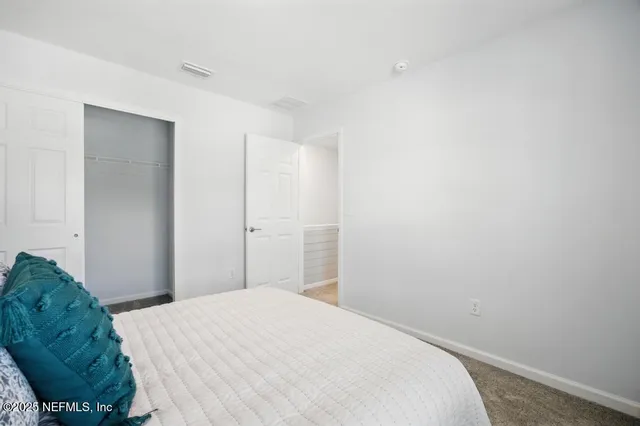 a bed room with a bed and a window