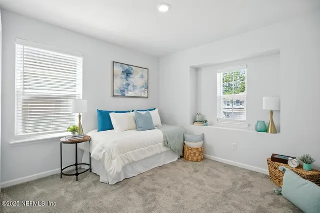 a bedroom with a bed and a large mirror