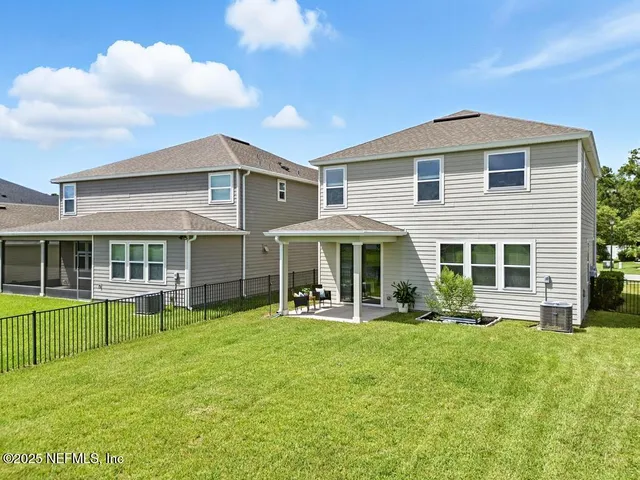 a front view of a house with a garden and plants