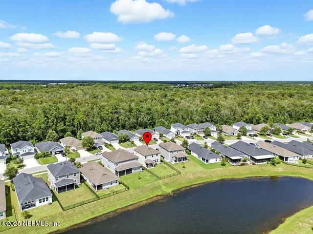 an aerial view of multiple houses with yard