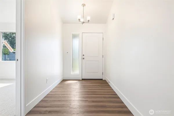 a view of a hallway with wooden floor