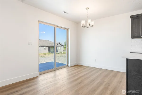 an empty room with cabinet and wooden floor